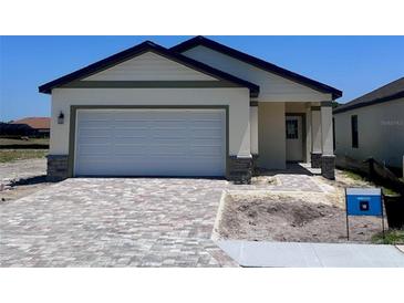 Charming single-Gathering home featuring a two-car garage and a stylish paved driveway on a clear sunny day at 3352 Cup Dr, Lakeland, FL 33803