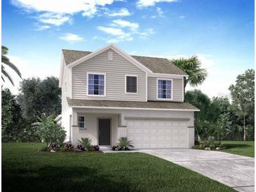 Two story home featuring a two car garage and well manicured lawn at 5579 Maddie Dr, Haines City, FL 33844