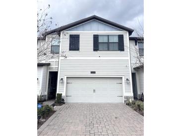 Beautiful two-story townhome with a two-car garage and paver driveway at 11588 Whistling Pine Way, Orlando, FL 32832