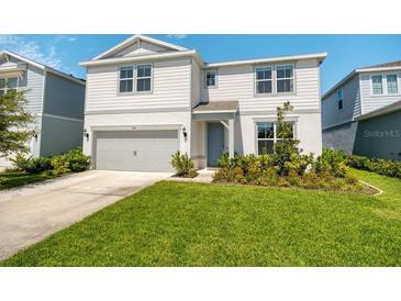 Charming two-story home with a well-maintained lawn and a two-car garage at 2714 Forestdale St, St Cloud, FL 34771