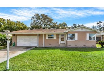 Charming single-story home with a well-maintained lawn and inviting curb appeal at 5715 Satel Dr, Orlando, FL 32810