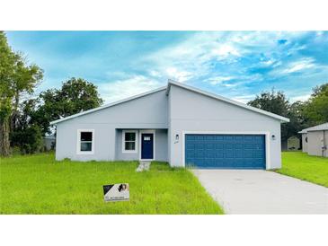 Charming single-story home with blue accents and a well-maintained lawn, creating a welcoming curb appeal at 656 Marion Oaks Mnr, Ocala, FL 34473