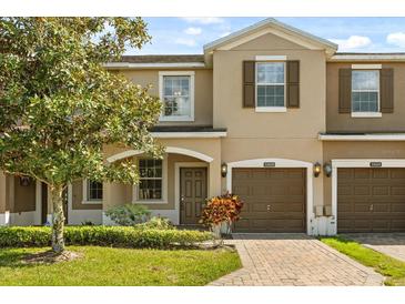 Charming townhome featuring a well-manicured lawn and a two-car garage, perfect for comfortable living at 10608 Savannah Plantation Ct, Orlando, FL 32832