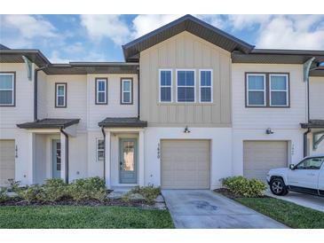 Charming two-story townhome features a one car garage and inviting front entrance at 1620 Pelican Dr, Davenport, FL 33896