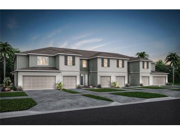 Charming townhome exterior with individual garages, lush lawns and sidewalks at 3133 Emerald Acres Ln, Sanford, FL 32771