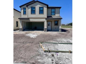 Charming two-story home with a garage and neutral color palette offers great curb appeal at 3165 Cup Dr, Lakeland, FL 33803