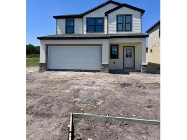Charming two-story home with a two-car garage and unfinished front yard at 3171 Cup Dr, Lakeland, FL 33803