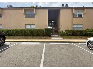 Neutral exterior of condo building with parking and stairs to units above the first floor at 370 N Windmeadows St # 370, Altamonte Springs, FL 32701