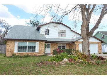Charming two-story brick home with well-maintained landscaping and inviting curb appeal at 5136 Stratemeyer Dr, Orlando, FL 32839
