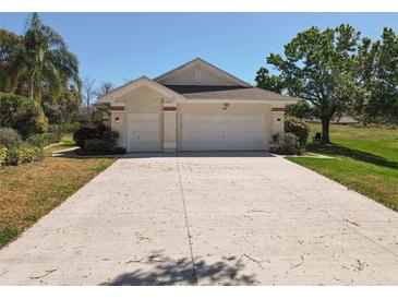 Charming single-story home featuring a three-car garage and manicured landscaping at 777 Crepe Myrtle Cir, Apopka, FL 32712