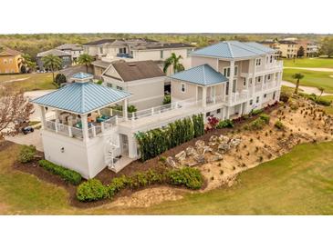 Stunning multi-story home with a unique spiral staircase and lush landscaping, perfect for outdoor living at 1432 Titian Ct, Reunion, FL 34747