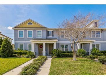 Charming two-story townhome with a well-maintained lawn and inviting front entrance at 15489 Honeybell Dr, Winter Garden, FL 34787