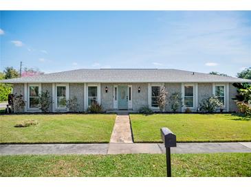 Charming single-story home boasts a well-manicured lawn and a welcoming light blue front door at 3117 Lake Mar Ln, Orlando, FL 32806