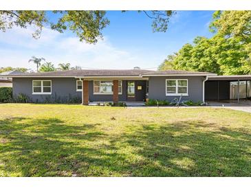Charming single-story home featuring a well-manicured lawn and a covered carport at 4210 Shorecrest Dr, Orlando, FL 32804
