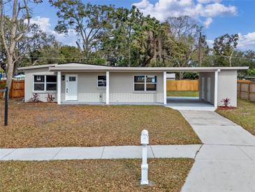 Charming single-story home featuring a covered carport, fresh paint, and a well-manicured front yard at 4215 Kildaire Ave, Orlando, FL 32812