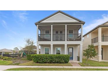 Charming two-story home featuring a welcoming double porch and verdant landscaping at 1763 White Feather Loop, Oakland, FL 34787