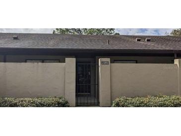 Townhome with private courtyard entrance and secure gate, offering privacy and curb appeal at 2284 Firestone Pl, Winter Haven, FL 33884