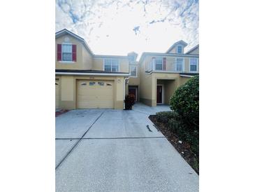 Townhome with attached garage and covered entryway at 2946 Ashland S Ln, Kissimmee, FL 34741