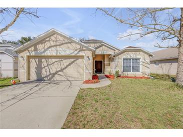 Charming single-story home featuring a two-car garage and a well-manicured front lawn at 615 Blue Park Rd, Orange City, FL 32763