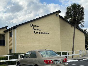 Exterior view of Destiny Springs Condominium building with lush landscaping at 946 Lake Destiny Rd # D, Altamonte Springs, FL 32714