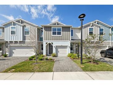 Charming townhome featuring a paved walkway and a one-car garage for convenient parking and curb appeal at 1412 Captiva Cv, Sanford, FL 32771