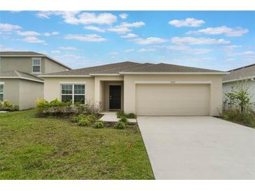 Charming single-Gathering home with a two-car garage and well-maintained front lawn at 3969 Southern Vista Loop, St Cloud, FL 34772