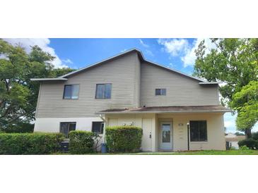 Charming two-story home with neutral siding and well-maintained landscaping in a suburban setting at 658 Olympic Dr, Ocoee, FL 34761