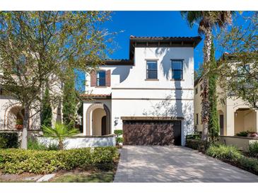 Charming two-story home featuring a terracotta tile roof and a manicured front yard at 8149 Via Vittoria Way, Orlando, FL 32819