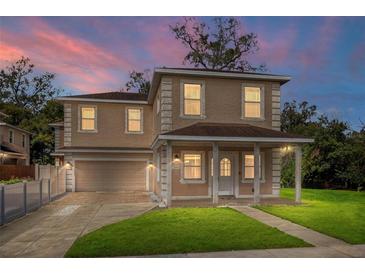 Charming two-story home boasts classic architecture, a covered front porch, and a well-maintained lawn, creating curb appeal at 1132 Hardy Ave Ave, Orlando, FL 32803