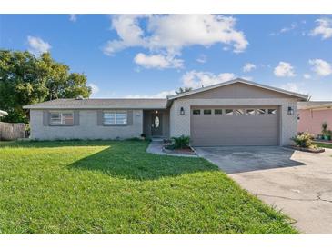 Charming single story home with brick exterior and well-maintained front yard at 1905 Diamond Dr, Orlando, FL 32807
