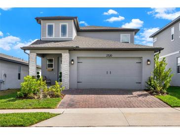 Charming two-story home featuring a two-car garage, brick driveway, and well-maintained landscaping at 2320 Treasure Hill St, Clermont, FL 34715