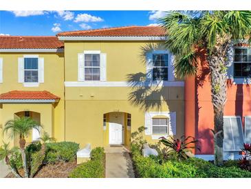 Charming townhome featuring a private entrance, well-maintained landscaping, and a vibrant, colorful facade at 3154 Yellow Lantana Ln, Kissimmee, FL 34747
