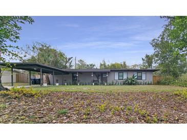 Charming single-story home with a covered carport and a well-maintained front yard at 5616 Clearview Dr, Orlando, FL 32819