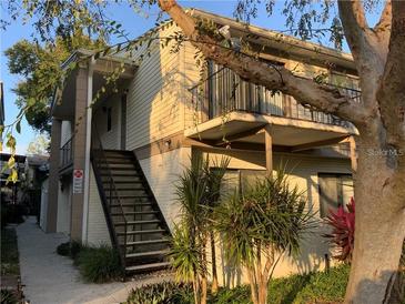Exterior view of a two-story apartment building with balconies and a staircase at 5951 Village Cir # Ge, Orlando, FL 32822