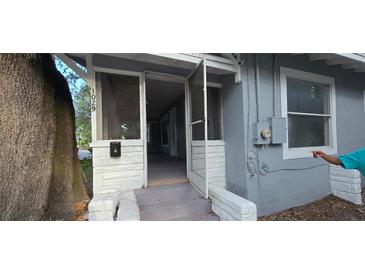 Charming front entrance with screen door, white accents, and steps leading into the home at 1029 Colyer St, Orlando, FL 32805