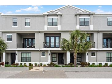 Charming townhome featuring a landscaped yard and balcony at 13042 Michael Callin Aly, Orlando, FL 32828