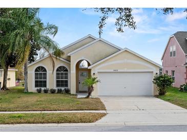 Charming single Gathering home with a well-manicured lawn and attached two car garage at 15832 Autumn Glen Ave, Clermont, FL 34714