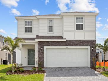 Charming two-story home with stone accents and attached two-car garage at 2221 Lelani Cir, Davenport, FL 33897