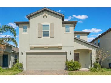 Charming two-story home featuring a two car garage and a neutral color scheme at 2811 Alpine Meadow Ln, Kissimmee, FL 34744