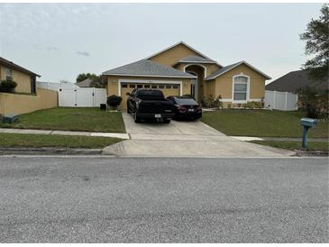 Charming single-Gathering home features a two-car garage, well-maintained lawn, and inviting curb appeal at 4411 Hazelton Ct, Orlando, FL 32818