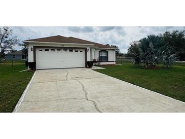 Charming single Gathering home featuring an attached two-car garage and a well-maintained lawn at 649 Gazelle Dr, Kissimmee, FL 34759