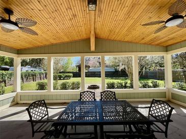 Covered patio featuring ceiling fans, outdoor furniture, and a view of the landscaped backyard at 171 Church St, Geneva, FL 32732