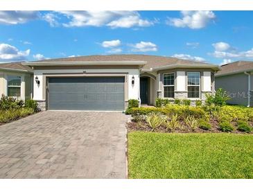 Charming single Gathering home with stone accents, a two-car garage, and a well-maintained front yard at 1972 Spring Shower Cir, Kissimmee, FL 34744