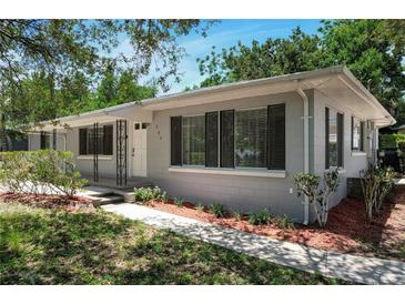 Charming single-story home with a well-manicured front yard, walkway and a gray exterior at 265 W Constance Rd, Debary, FL 32713