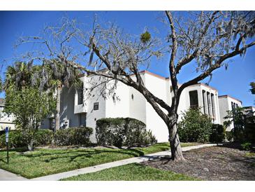 Well-maintained exterior of a condo building featuring lush landscaping and a welcoming walkway at 506 Orange Dr # 22, Altamonte Springs, FL 32701