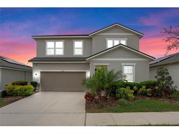 Charming two-story home features a well-maintained yard, neutral exterior paint and attached two car garage at 580 Buchannan Dr, Davenport, FL 33837