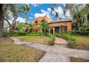 Charming Spanish-style home with lush landscaping, mature trees, and a tile roof at 1141 S Osceola Ave, Orlando, FL 32806