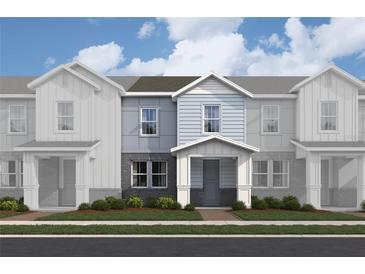 Charming new construction townhome with brick accents, inviting porch, and neat landscaping at 167 Aulin Ave, Oviedo, FL 32765