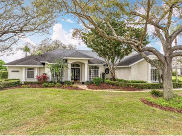 Charming one-story home featuring a manicured lawn and mature landscaping, showcasing curb appeal at 2026 Willow Lauren Ln, Windermere, FL 34786