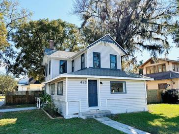 Charming two-story home with a beautifully landscaped yard and classic architectural details at 428 E Orange Ave, Eustis, FL 32726